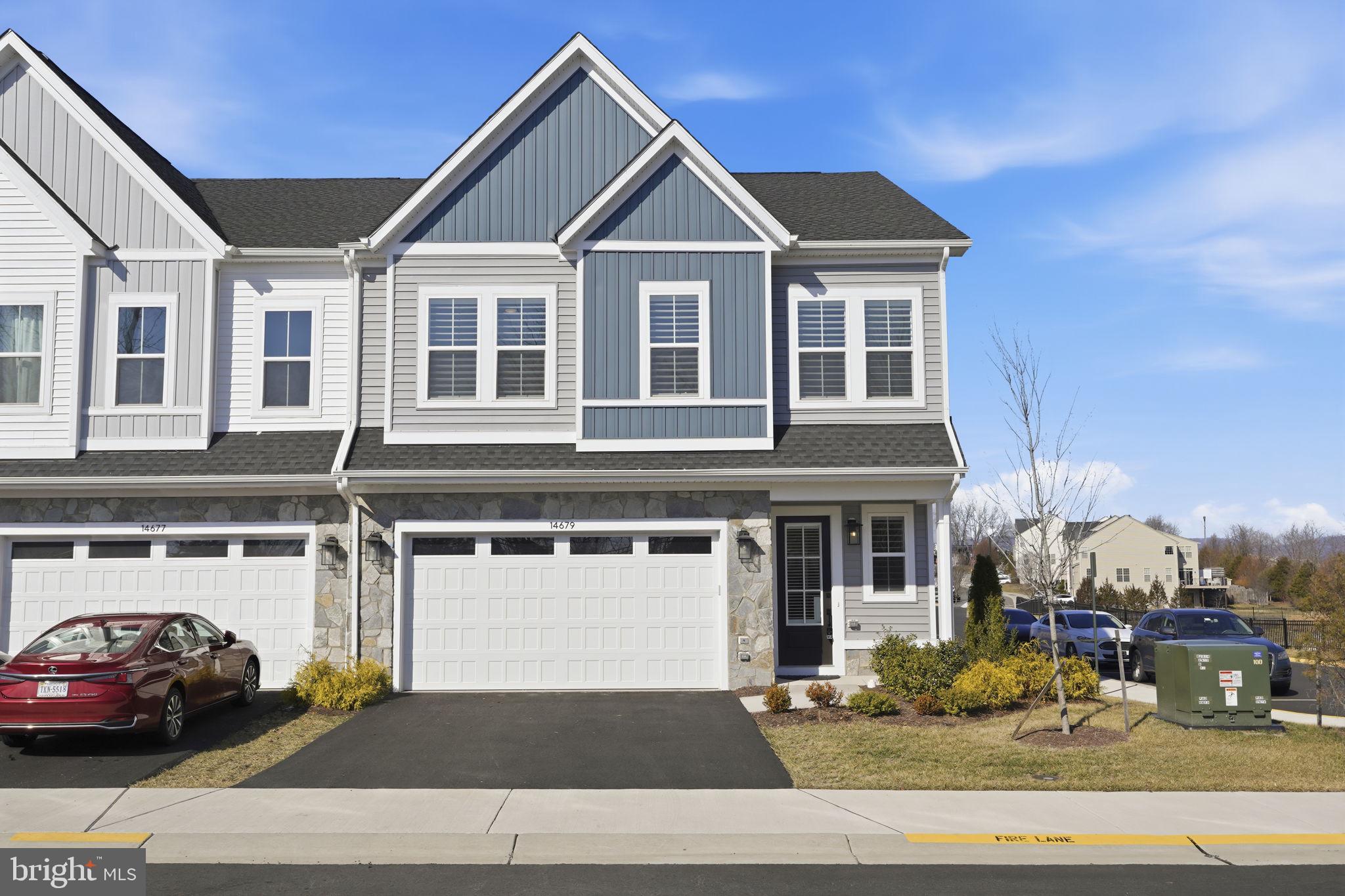 14679 Grand Cru Loop Gainesville, VA 20155 - Photo 36 of 41 a front view of a house with cars parked on road