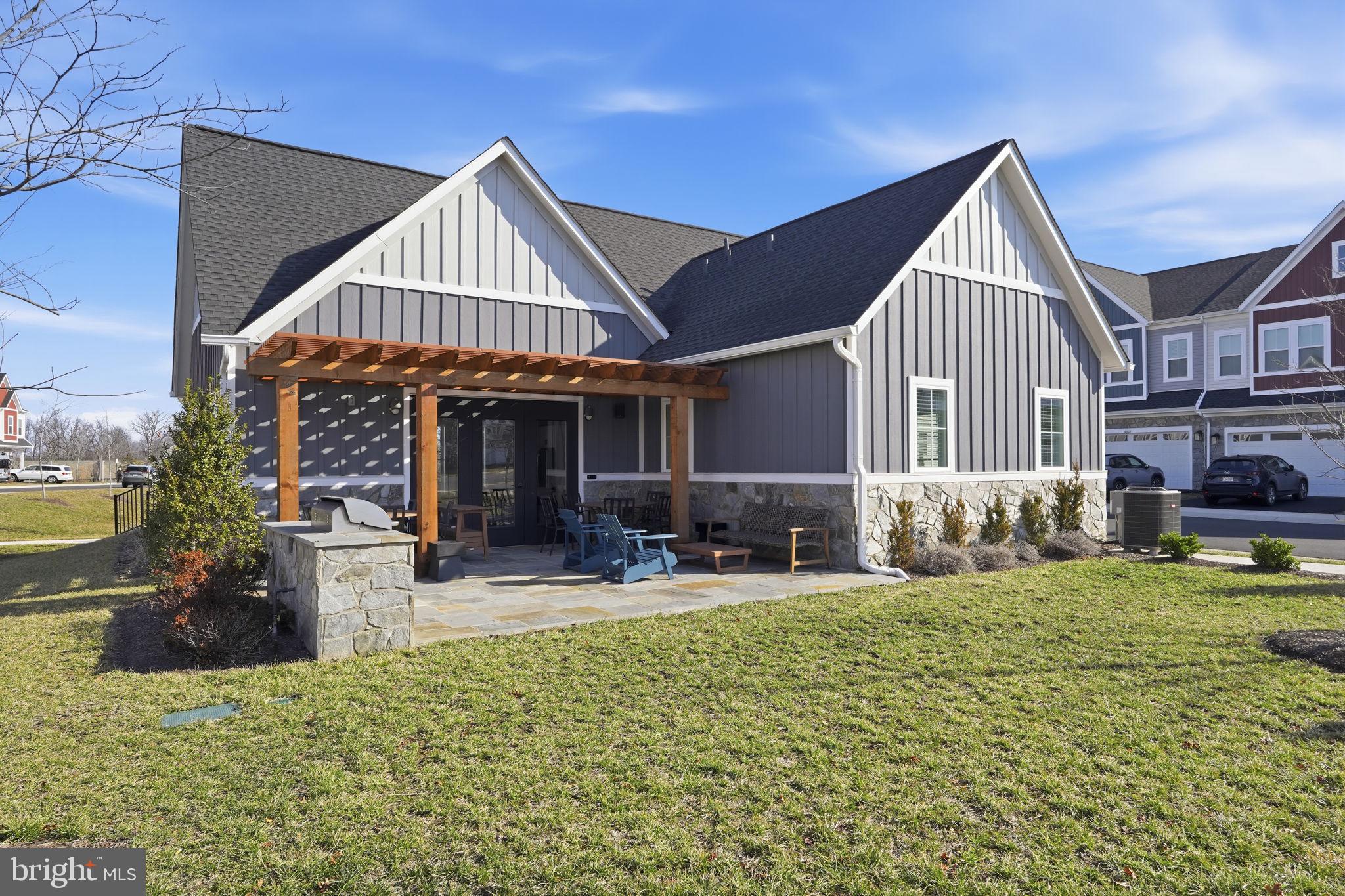 14679 Grand Cru Loop Gainesville, VA 20155 - Photo 37 of 41 a view of a house with a yard patio and fire pit