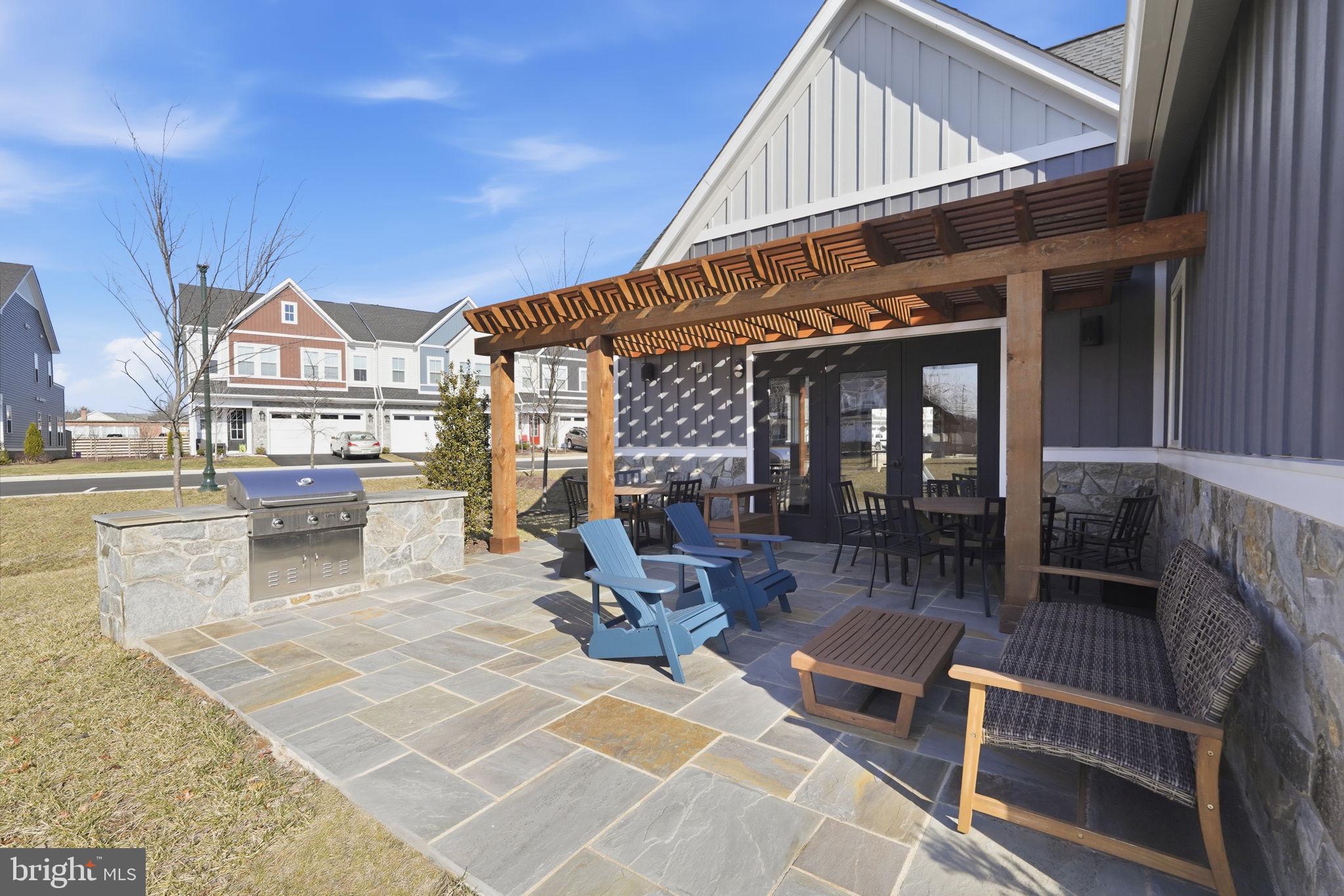 14679 Grand Cru Loop Gainesville, VA 20155 - Photo 38 of 41 a building outdoor space with patio furniture and potted plants