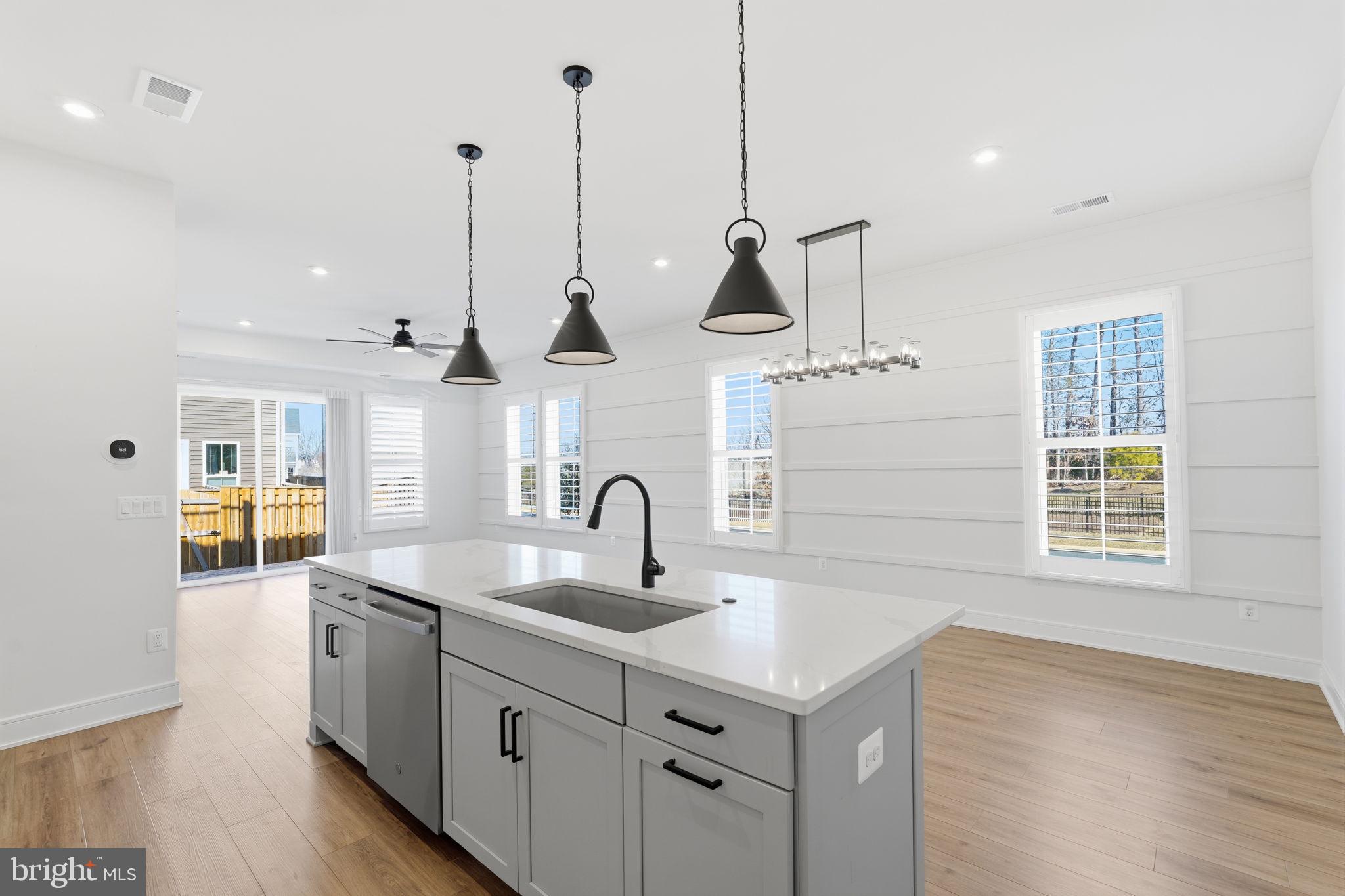 14679 Grand Cru Loop Gainesville, VA 20155 - Photo 7 of 41 a kitchen with sink cabinets and wooden floor