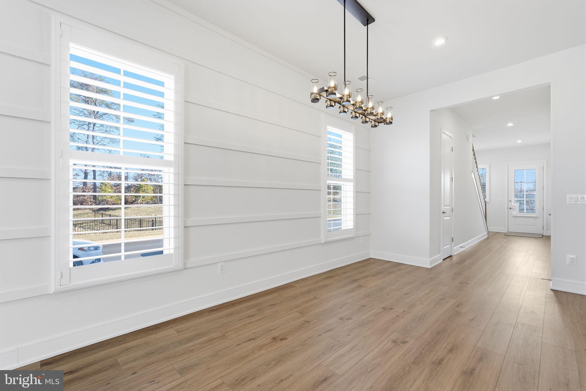14679 Grand Cru Loop Gainesville, VA 20155 - Photo 9 of 41 an empty room with wooden floor and windows