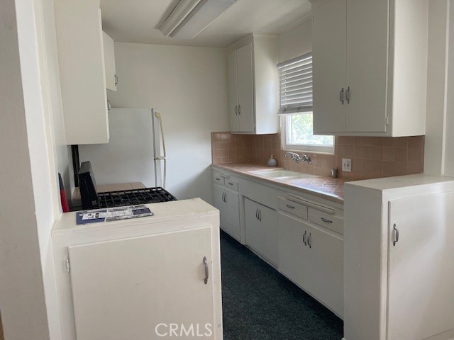 14225 Riverside Drive Sherman Oaks, CA 91423 - Photo 7 of 15 a kitchen with cabinets appliances a sink and a window