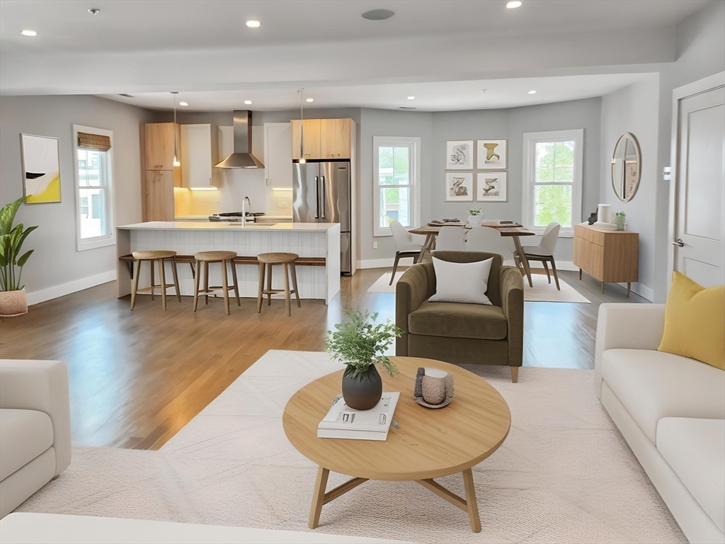 a living room with furniture potted plant and a wooden floor