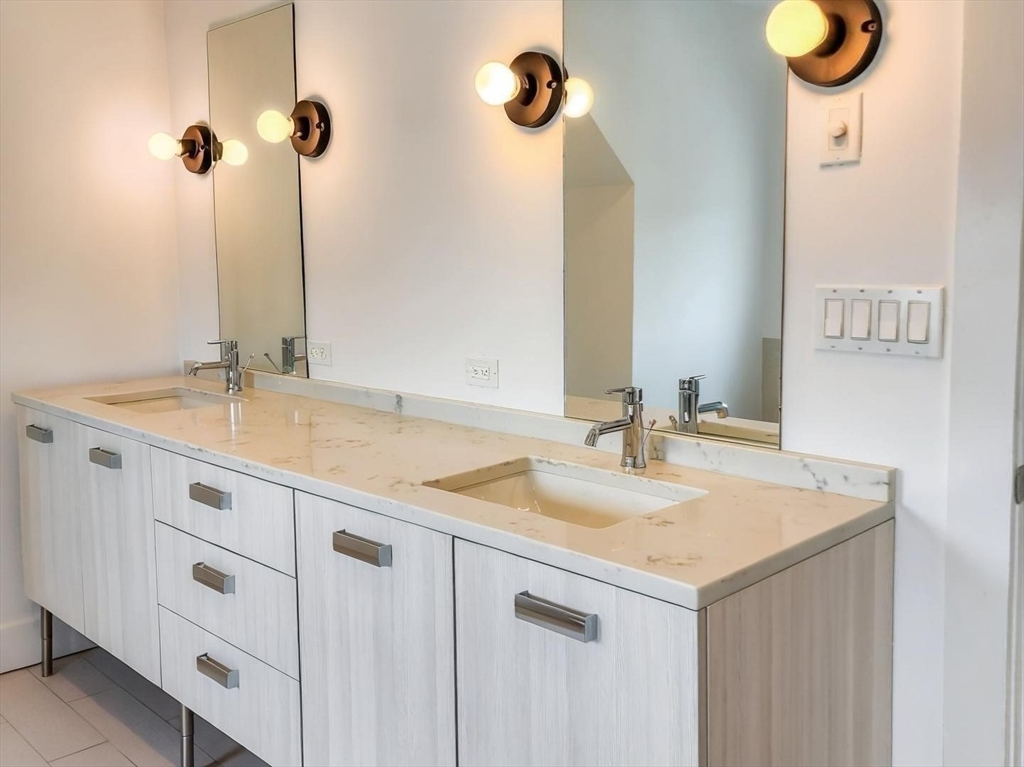 84 Romsey Street, Unit 3 Boston, MA 02125 - Photo 12 of 22 a bathroom with a sink and a mirror