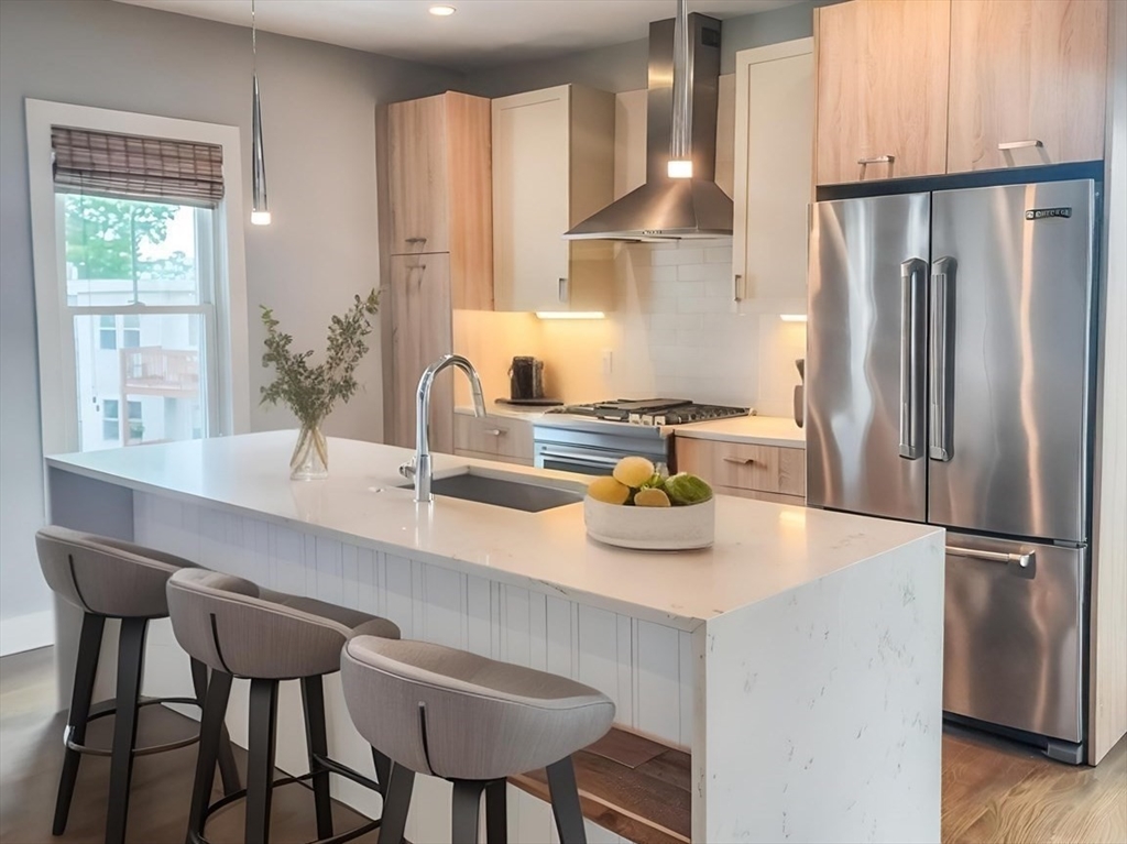 84 Romsey Street, Unit 3 Boston, MA 02125 - Photo 2 of 22 a kitchen with refrigerator and chairs