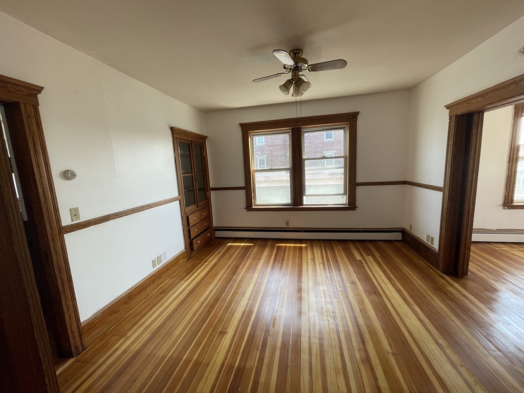 25 Perkins Street, Unit 3 Salem, MA 01970 - Photo 2 of 8 wooden floor in an empty room with a window
