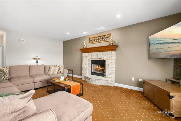 a living room with furniture and a fireplace
