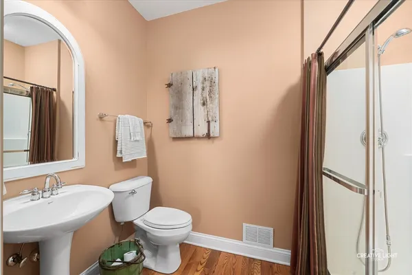 a bathroom with a toilet sink vanity and mirror