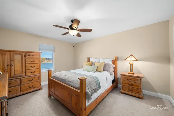 a bedroom with a bed and a chandelier