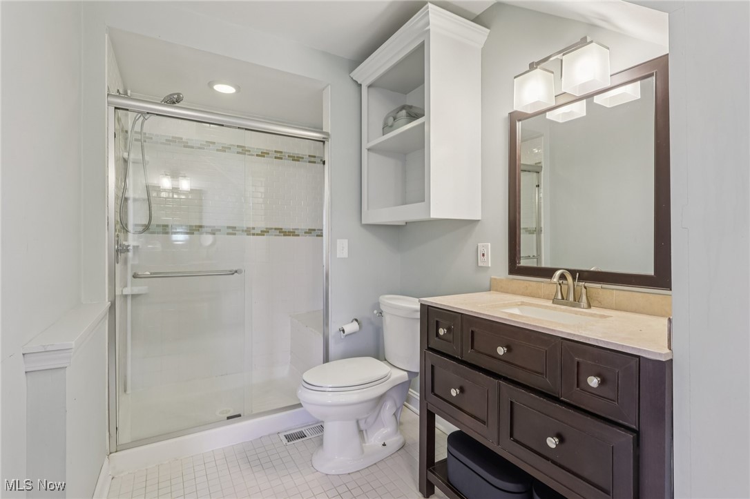 17024 Fernway Road Cleveland, OH 44120 - Photo 26 of 46 Primary Bathroom with vanity, a shower stall, and tiled floors