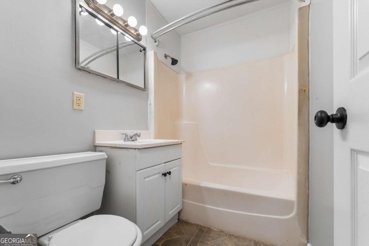 320 West Whatley Street Pooler, GA 31322 - Photo 12 of 34 a bathroom with a sink a mirror toilet and bathtub