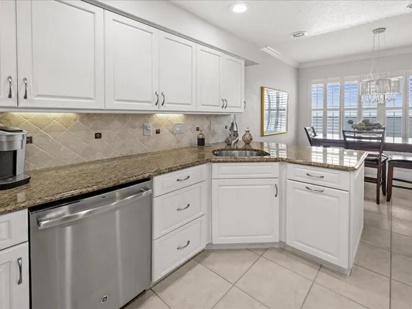 a kitchen with cabinets appliances a sink and a counter top space