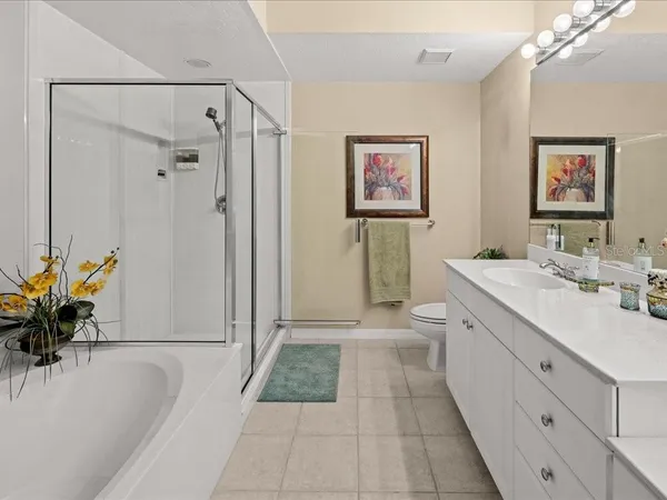 a bathroom with a tub sink and mirror