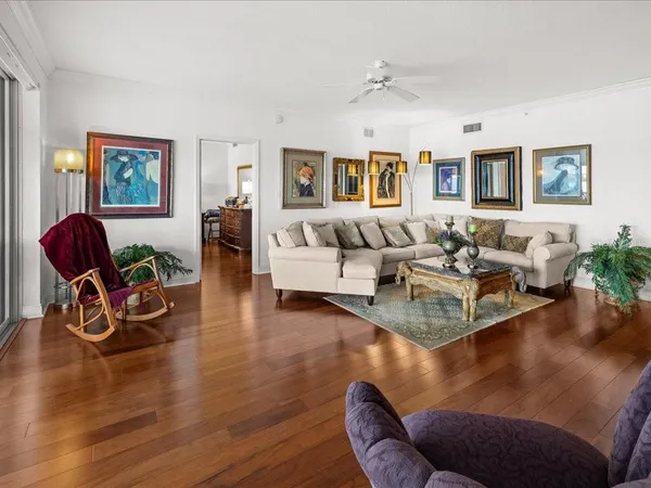 a living room with furniture fireplace and wooden floor