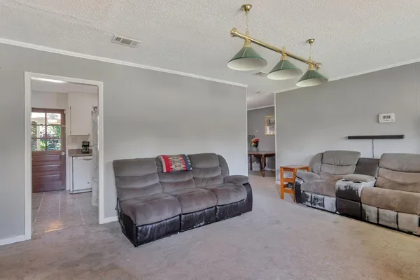 a living room with furniture and a ceiling fan