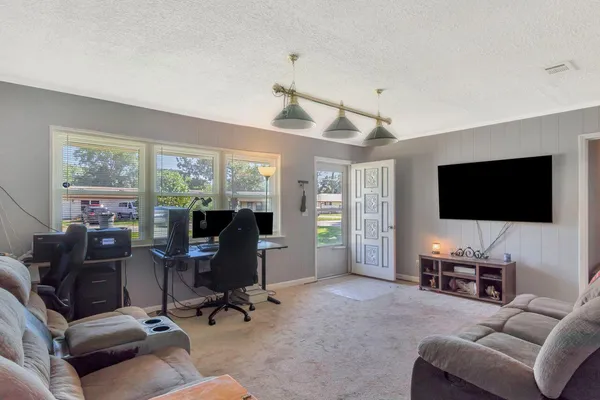 a view of a livingroom with workspace and a window
