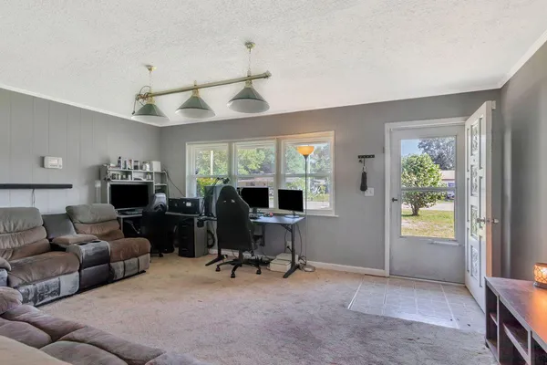 a view of a livingroom with workspace and a window