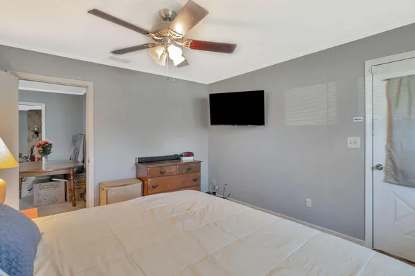 a bedroom with a bed and a flat screen tv