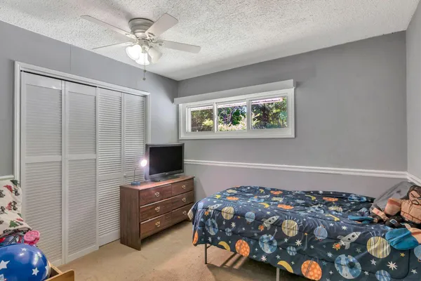 a bedroom with a bed and a chandelier