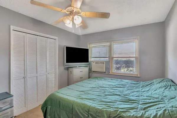 a bedroom with a bed and a flat screen tv