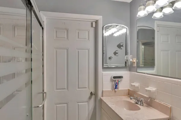 a bathroom with a sink vanity and a mirror