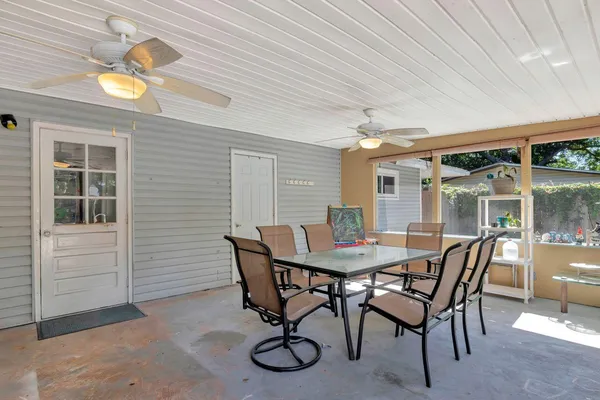 a view of a patio with table and chairs and potted plants