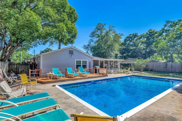 a swimming pool with outdoor seating and yard