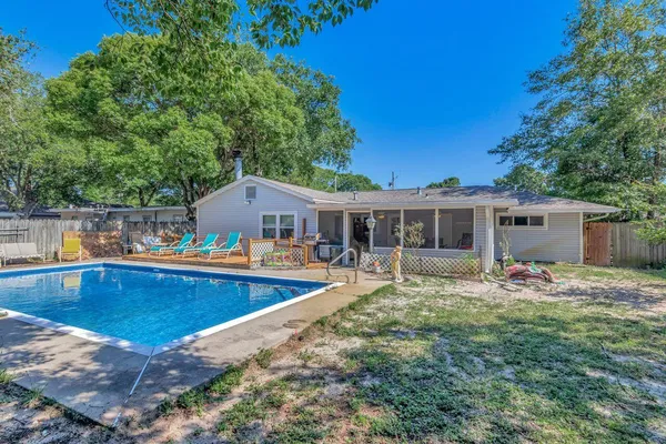 a view of a house with swimming pool and sitting area
