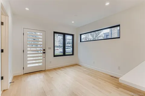 an empty room with windows and closet