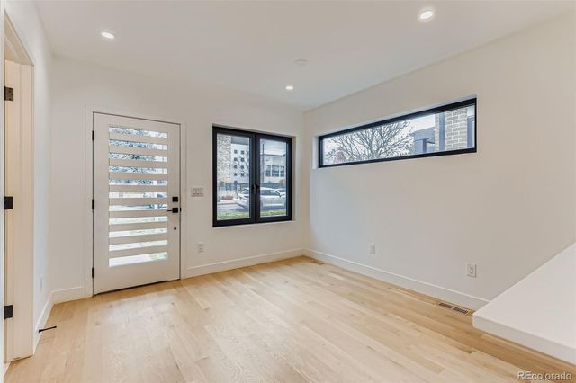 an empty room with windows and closet