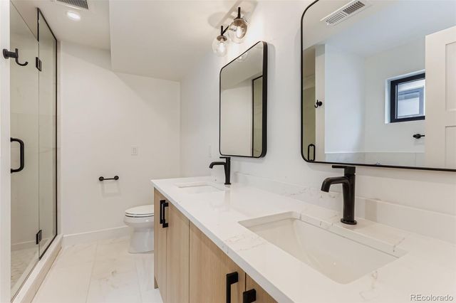 a bathroom with 2 sink and a mirror