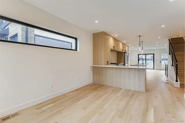 a view of kitchen with cabinets and wooden floor