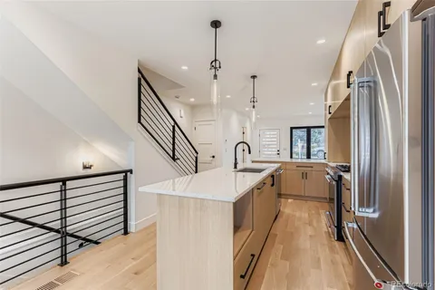 a kitchen with stainless steel appliances a refrigerator and a sink