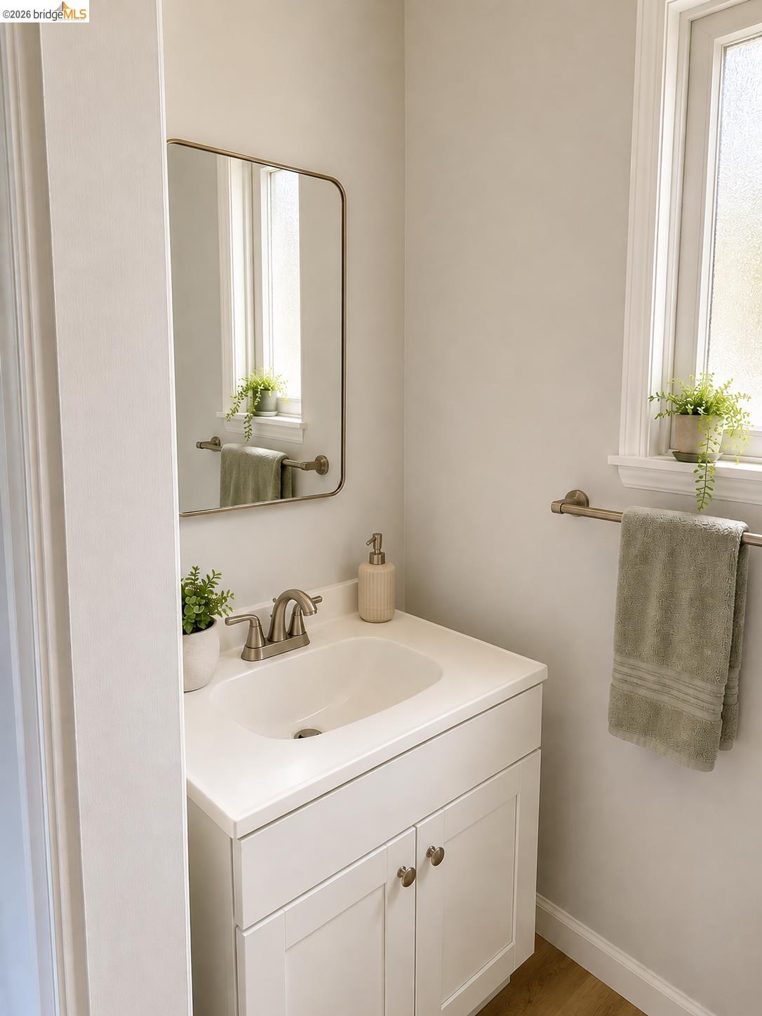 269 Crescent Drive Rio Vista, CA 94571 - Photo 5 of 9 Bathroom vanity featuring white cabinetry with brushed nickel hardware, an integrated sink, and coordinating brushed nickel faucet