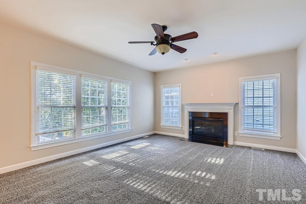 6040 Big Sandy Drive Raleigh, NC 27616 - Photo 11 of 28 a view of an empty room with a fireplace and a window