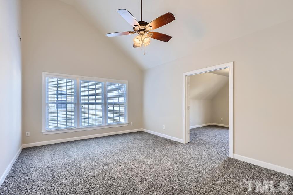6040 Big Sandy Drive Raleigh, NC 27616 - Photo 13 of 28 an empty room with chandelier fan and windows