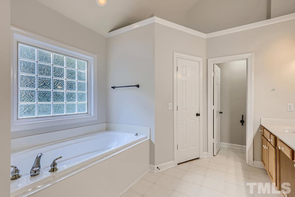 6040 Big Sandy Drive Raleigh, NC 27616 - Photo 15 of 28 a bathroom with a tub sink and a window