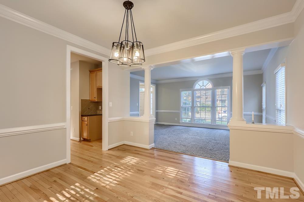 6040 Big Sandy Drive Raleigh, NC 27616 - Photo 6 of 28 a view of a livingroom with wooden floor and a chandelier