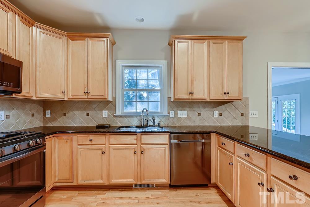 6040 Big Sandy Drive Raleigh, NC 27616 - Photo 8 of 28 a kitchen with granite countertop a sink stainless steel appliances and cabinets