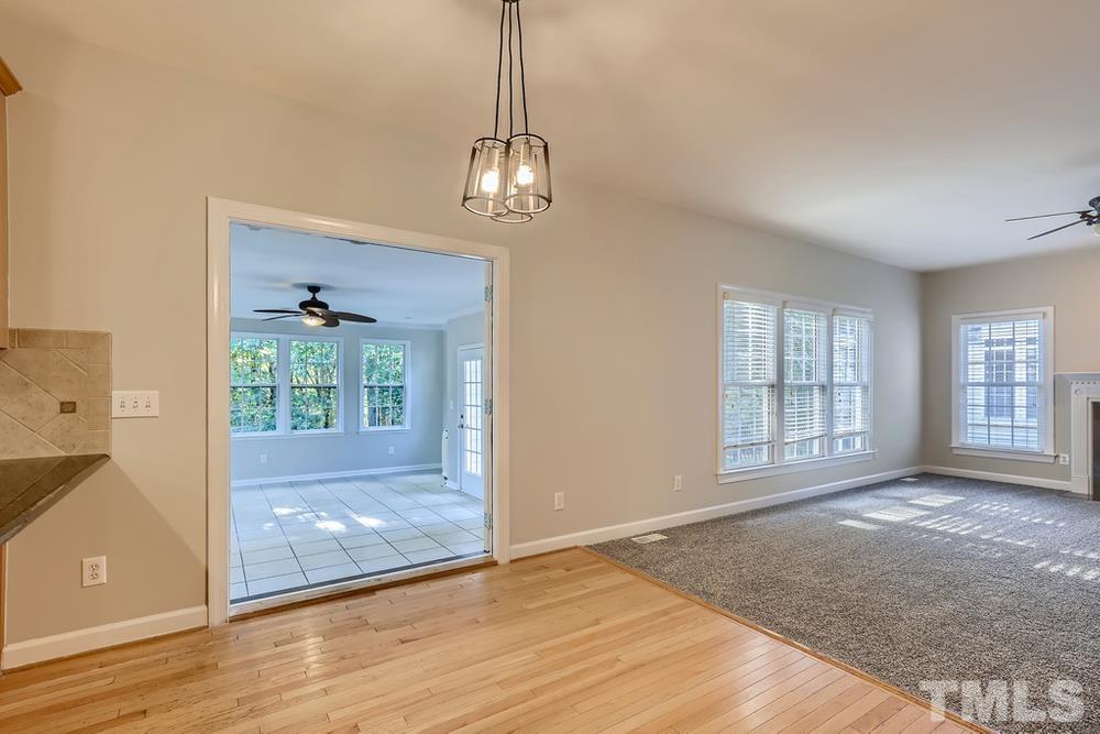 6040 Big Sandy Drive Raleigh, NC 27616 - Photo 10 of 28 a view of empty room with wooden floor and fan