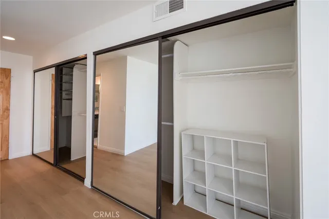 a view of walk in closet with empty racks