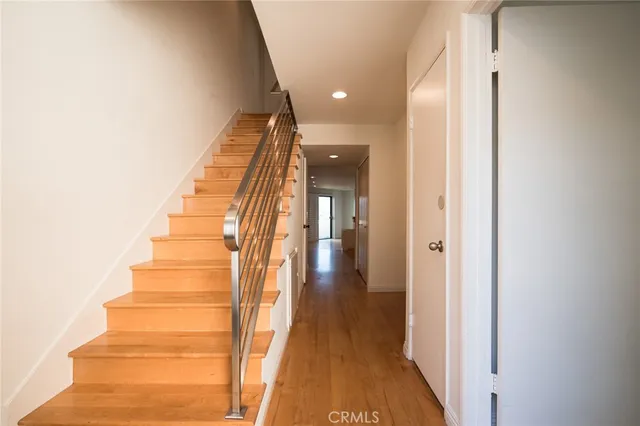 a view of a hallway with wooden floor and entryway