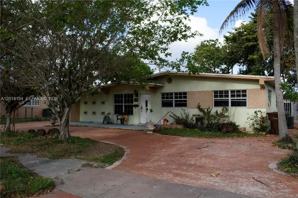 a front view of a house with garden and porch