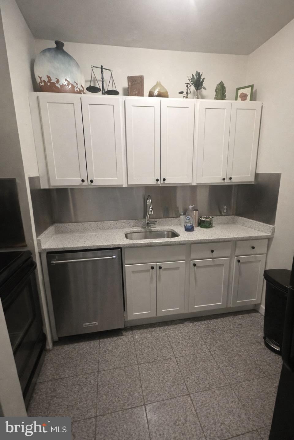 414 South 15th Street, Unit 1R Philadelphia, PA 19146 - Photo 1 of 16 a kitchen with a sink window and cabinets