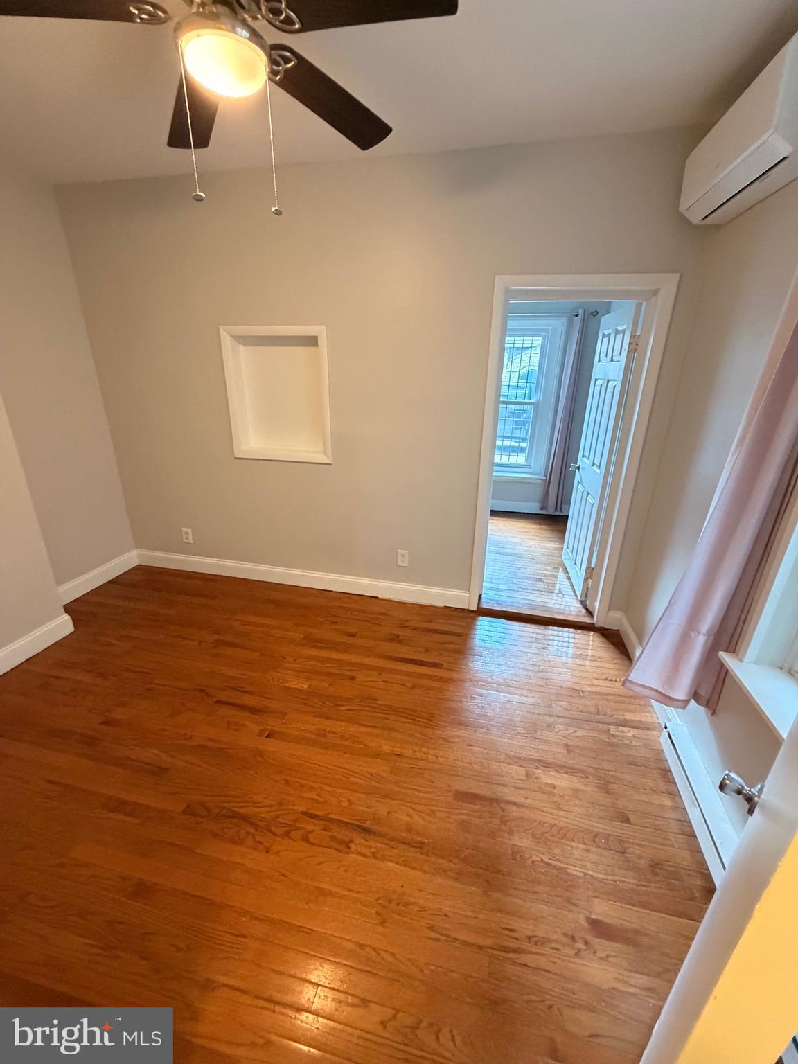 414 South 15th Street, Unit 1R Philadelphia, PA 19146 - Photo 11 of 16 wooden floor in an empty room with a window