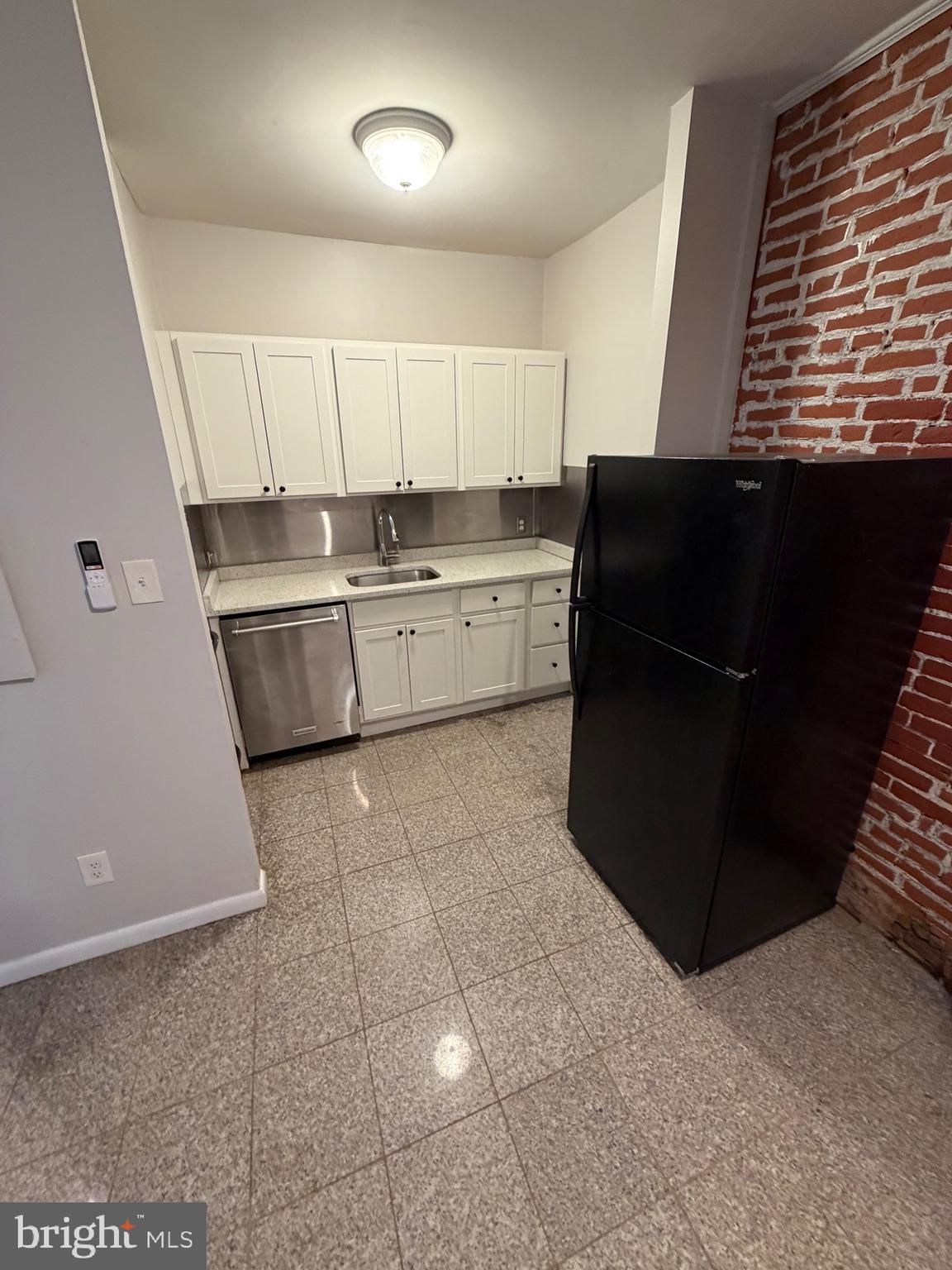 414 South 15th Street, Unit 1R Philadelphia, PA 19146 - Photo 15 of 16 a kitchen with a sink a refrigerator and cabinets