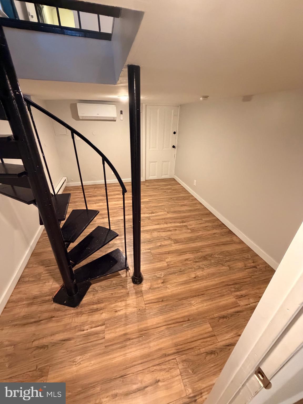 414 South 15th Street, Unit 1R Philadelphia, PA 19146 - Photo 7 of 16 a room with wooden floor and white walls