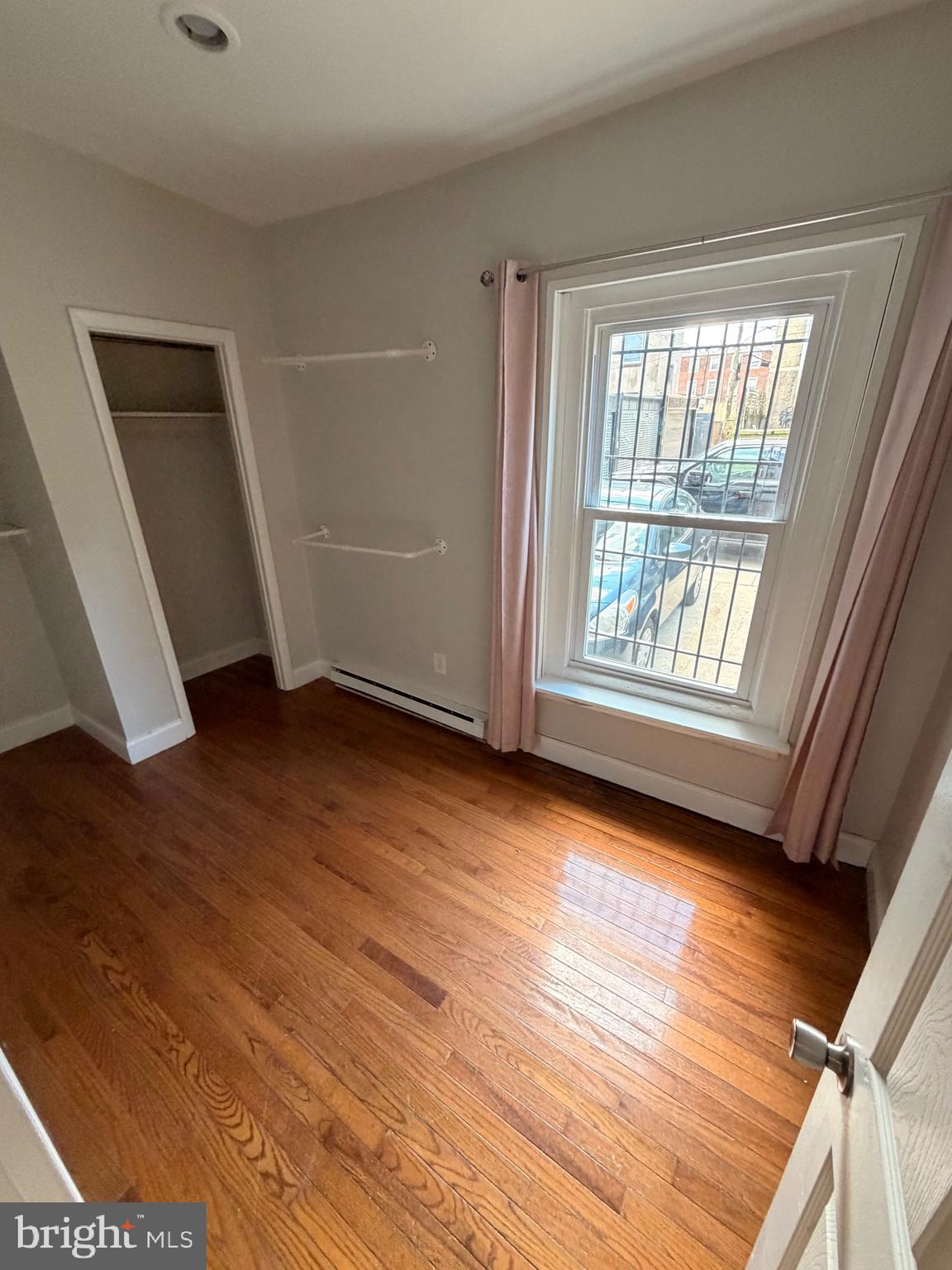 414 South 15th Street, Unit 1R Philadelphia, PA 19146 - Photo 9 of 16 a view of an empty room with wooden floor and a window