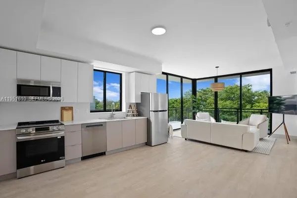 a living room with furniture and a floor to ceiling window