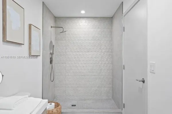 a bathroom with a double vanity sink toilet mirror and shower